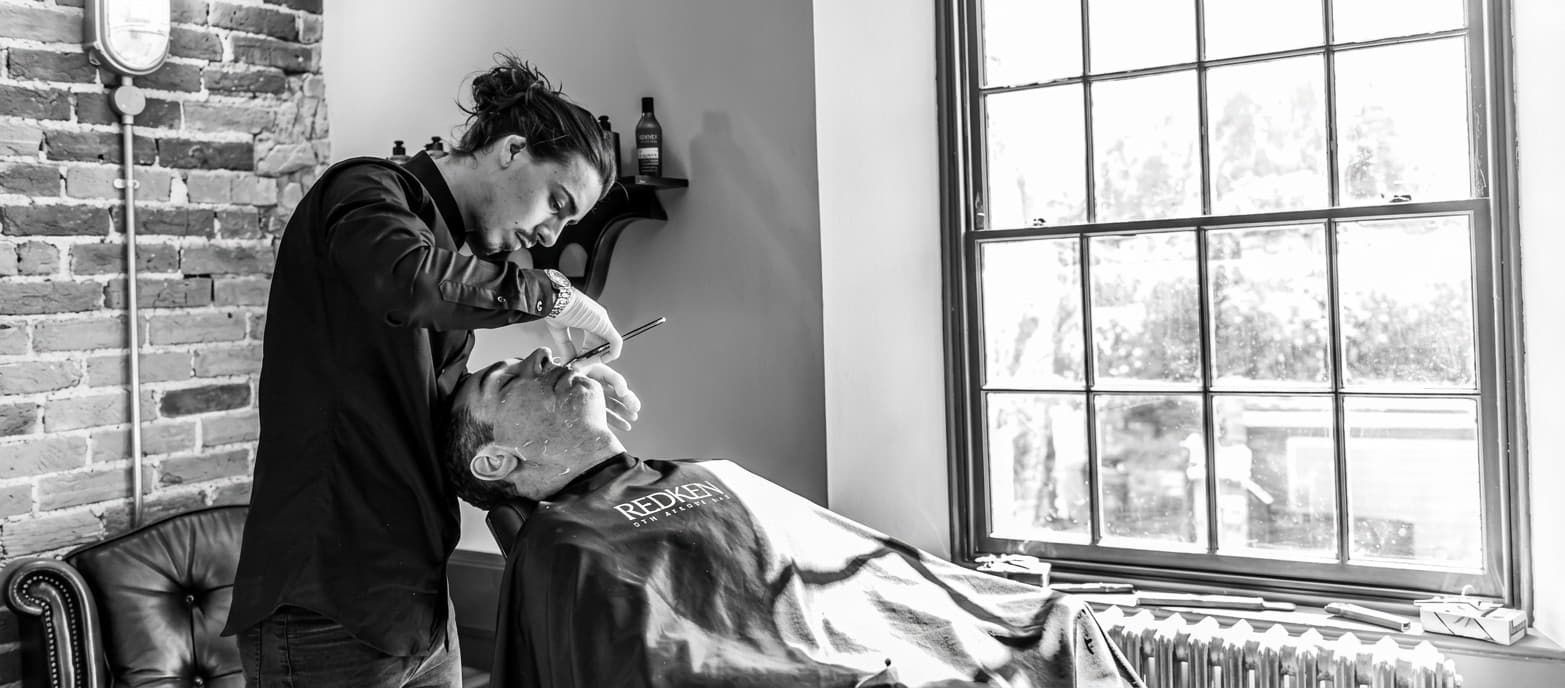 A client having a cut-throat razor shave